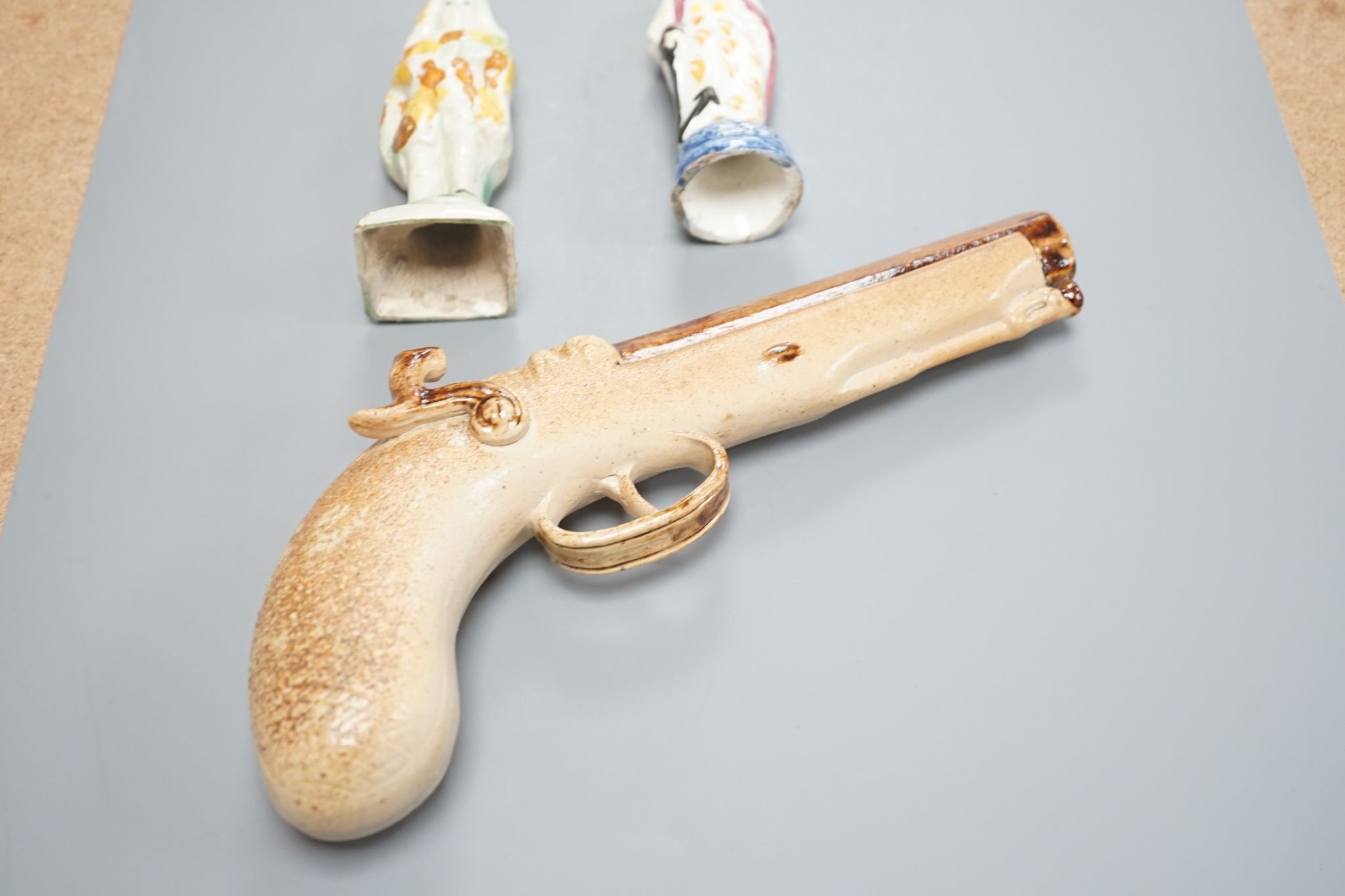 Two prattware figures circa 1800. and a salt-glazed pistol 25cm